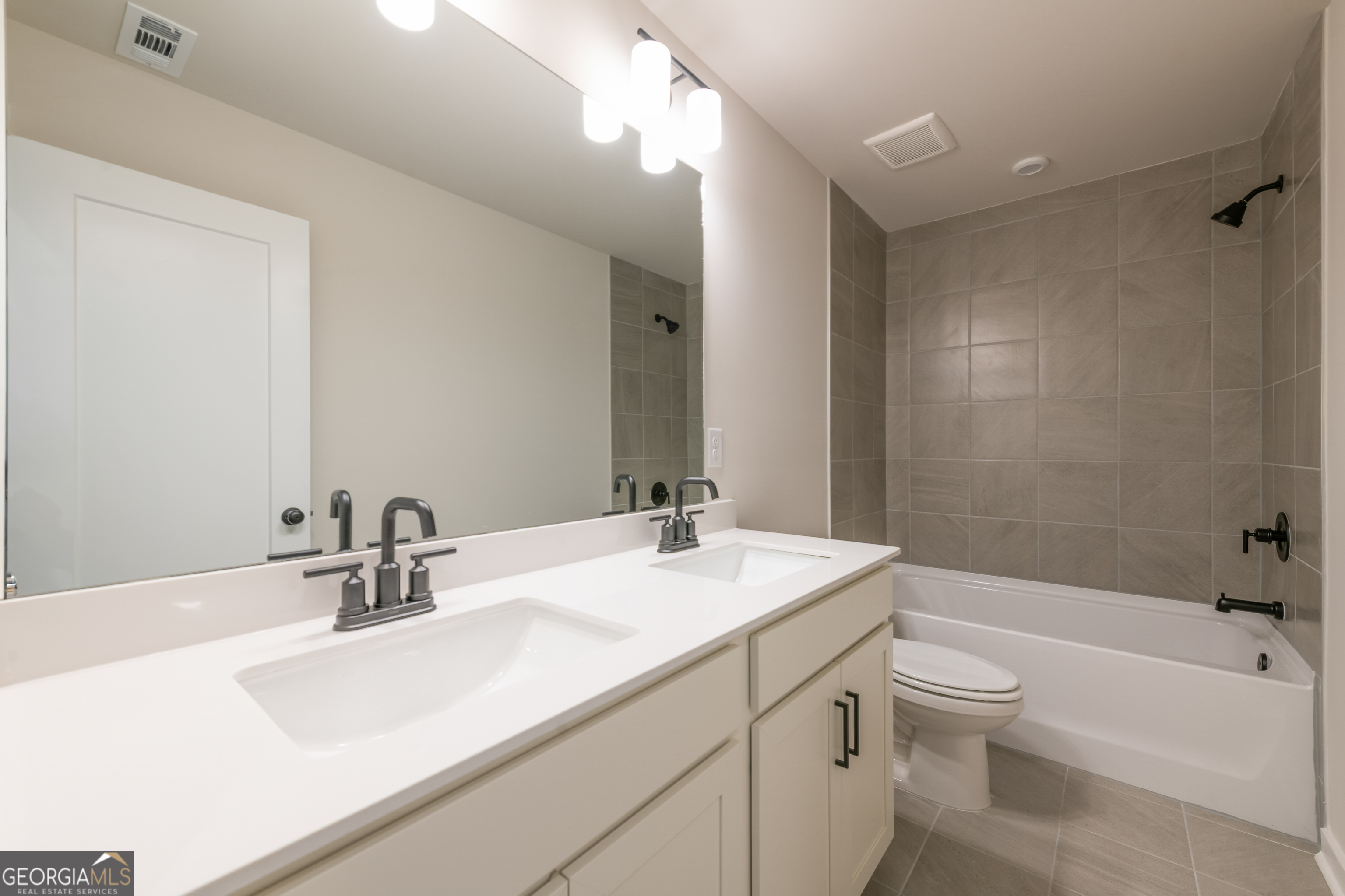 152 Henley Street, Unit 13 Canton, GA 30114 - Photo 26 of 37 a bathroom with a sink a toilet and shower