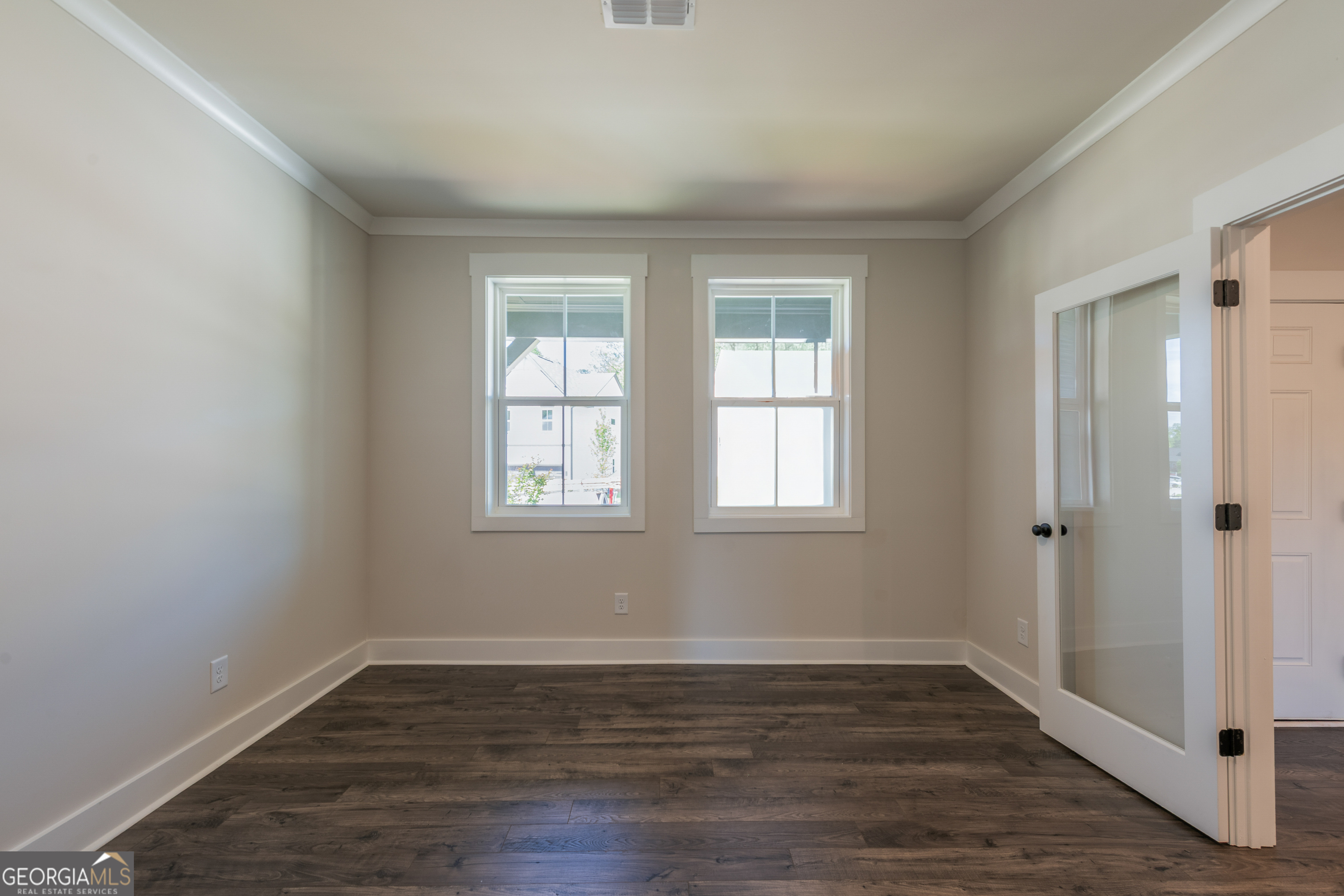 152 Henley Street, Unit 13 Canton, GA 30114 - Photo 3 of 37 a view of an empty room with wooden floor and a window