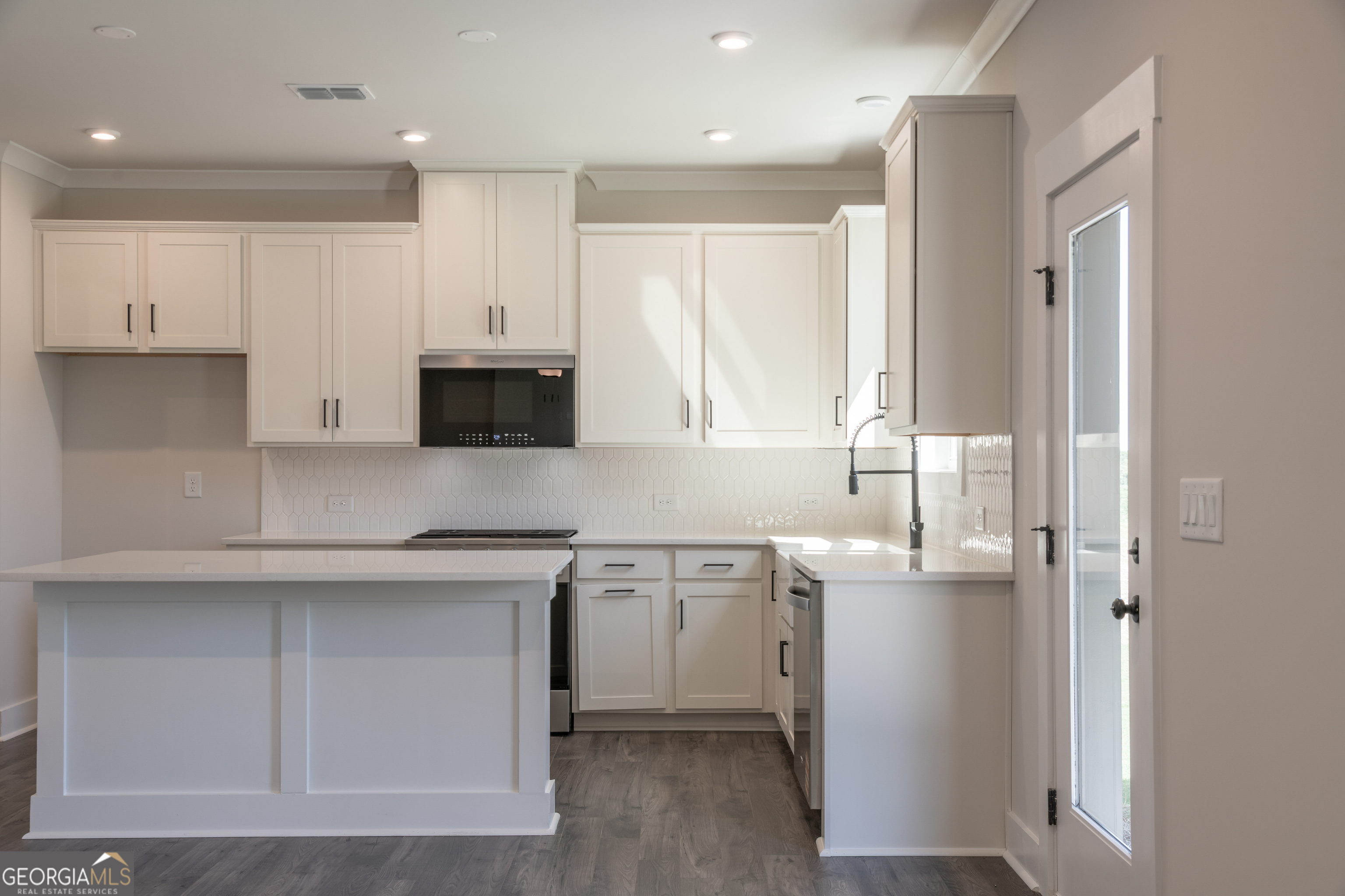 152 Henley Street, Unit 13 Canton, GA 30114 - Photo 7 of 37 a kitchen with stainless steel appliances a sink a stove a microwave a refrigerator a window and cabinets