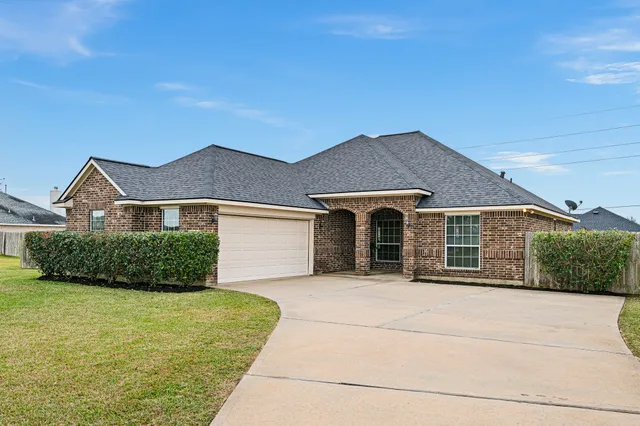 a front view of a house with yard and garage