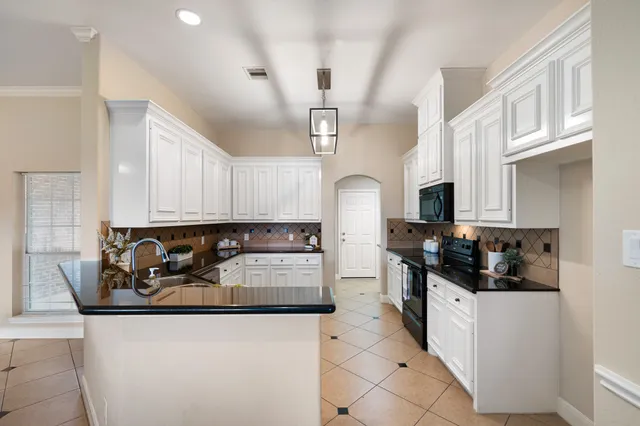 a kitchen with stainless steel appliances granite countertop a sink and cabinets