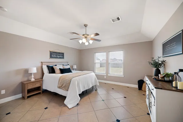 a spacious bedroom with a bed and a window