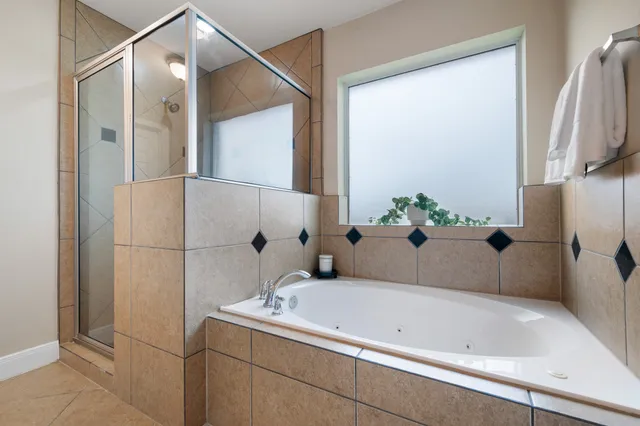a bathroom with a tub and shower