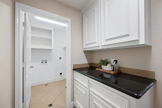 a kitchen with white cabinets and a sink