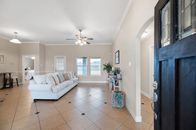 a living room with furniture and a chandelier