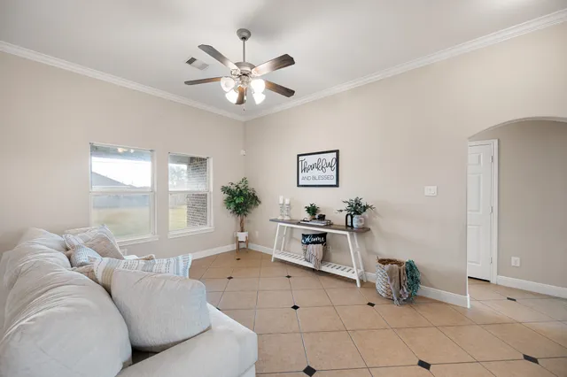 a living room with furniture and a large window