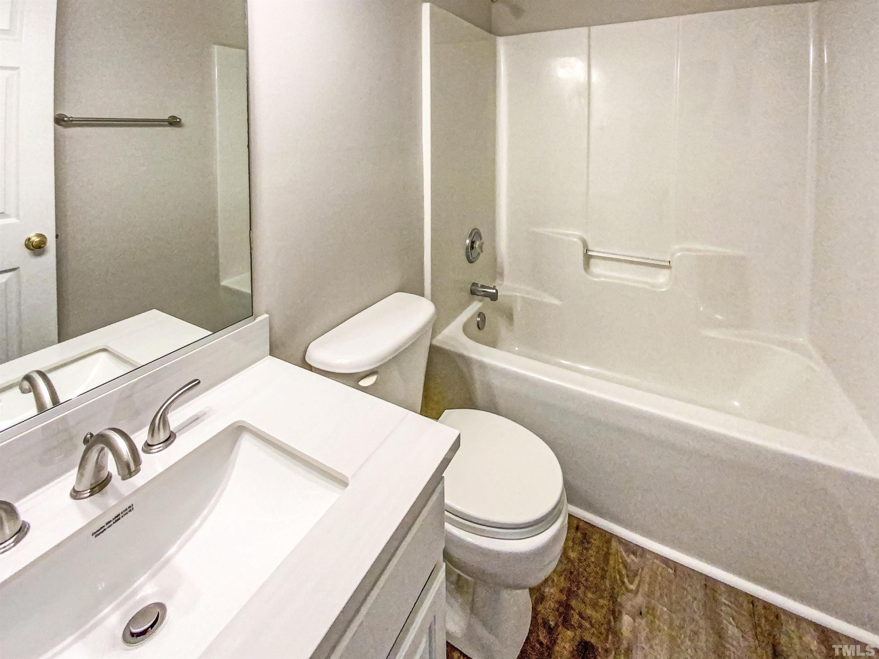 203 Caley Road Apex, NC 27502 - Photo 17 of 19 a bathroom with a sink a toilet and bathtub