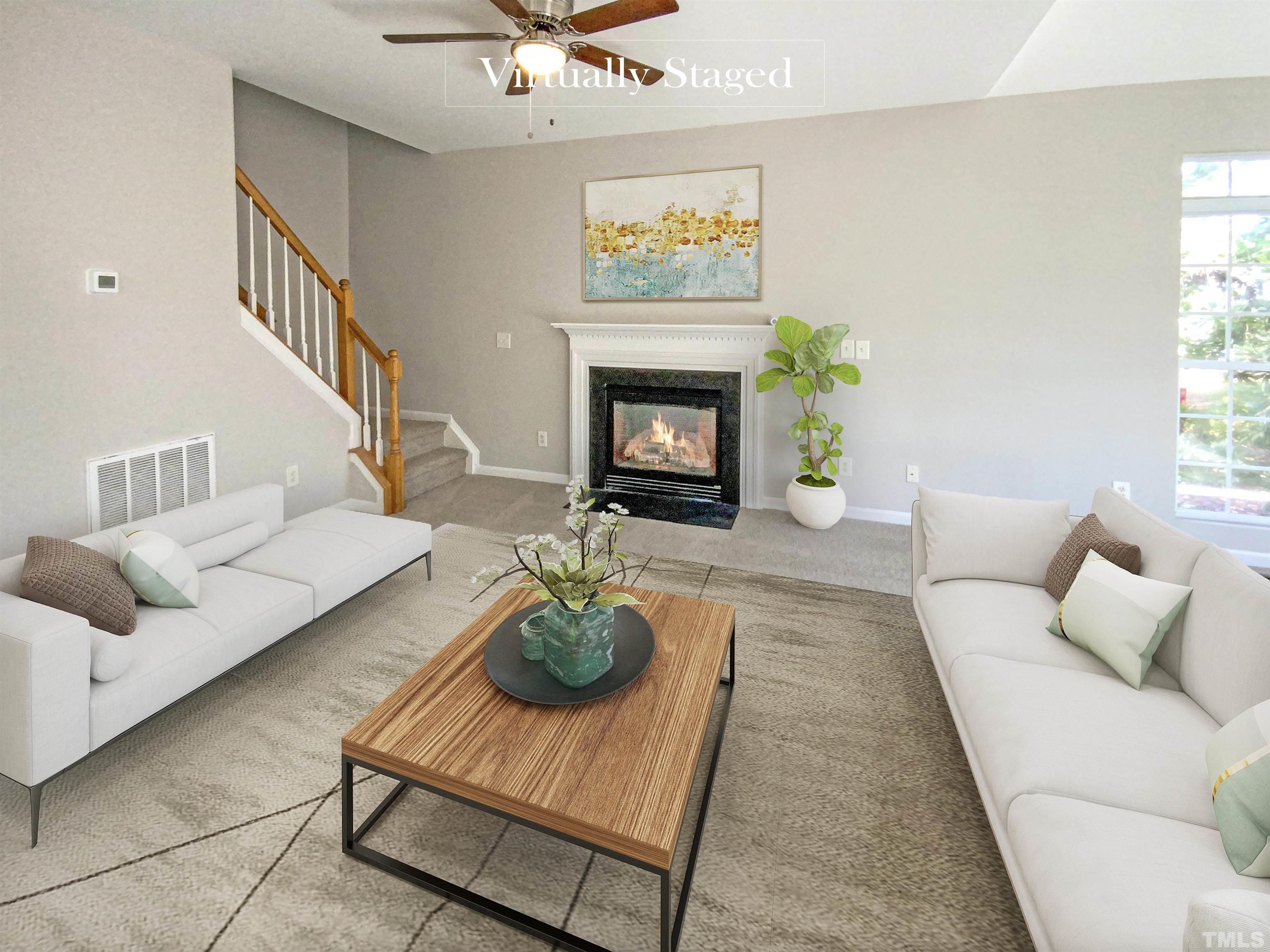 203 Caley Road Apex, NC 27502 - Photo 2 of 19 a living room with furniture and a fireplace
