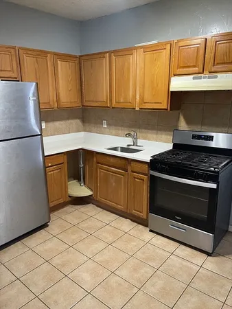 a kitchen with a sink stove and cabinets
