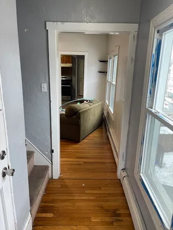 a view of a hallway view with wooden floor and staircase