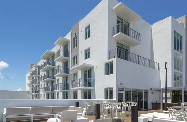 a view of swimming pool with outdoor seating and city view