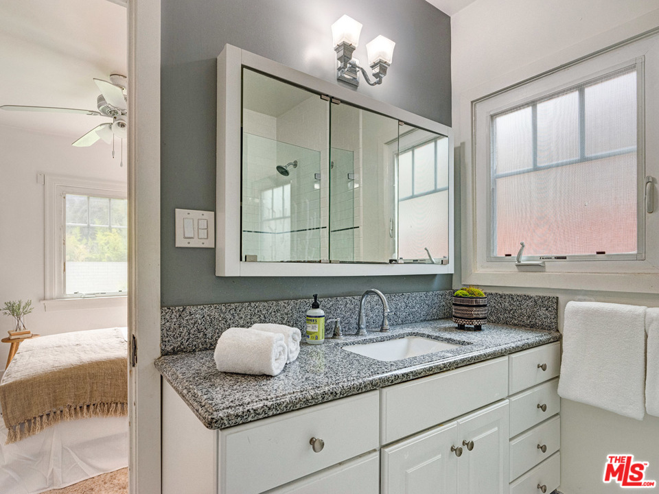 241 Ruth Avenue Venice, CA 90291 - Photo 12 of 25 a bathroom with a granite countertop sink and a mirror