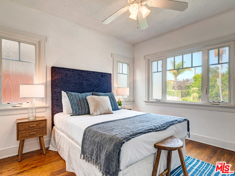 241 Ruth Avenue Venice, CA 90291 - Photo 13 of 25 a bedroom with a large bed and a chandelier