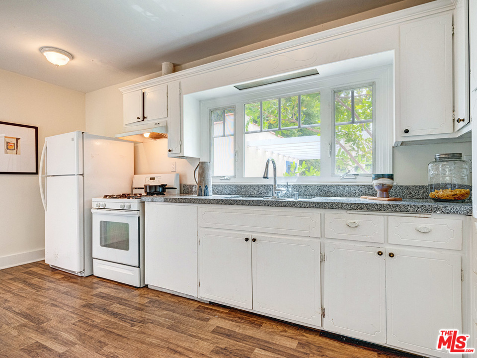 241 Ruth Avenue Venice, CA 90291 - Photo 16 of 25 a kitchen with granite countertop white cabinets and white appliances