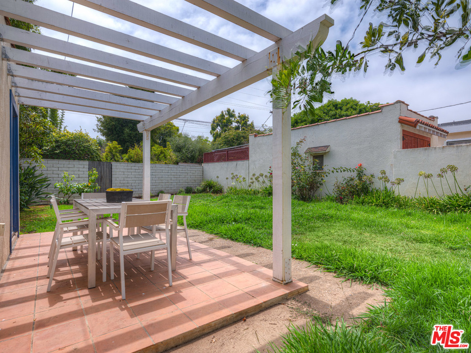 241 Ruth Avenue Venice, CA 90291 - Photo 19 of 25 a view of a patio with table and chairs potted plants and palm trees