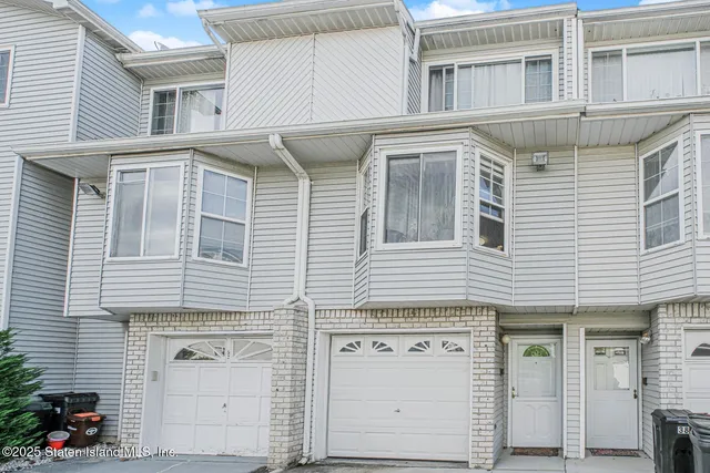 a view of a house with white doors and two windows