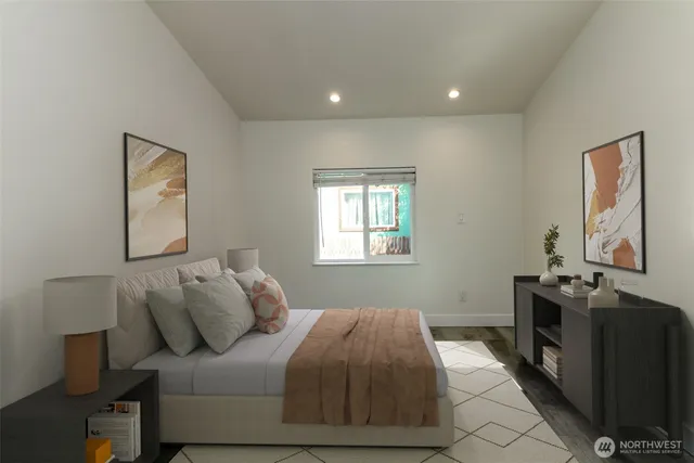 a bedroom with a bed and wooden floor