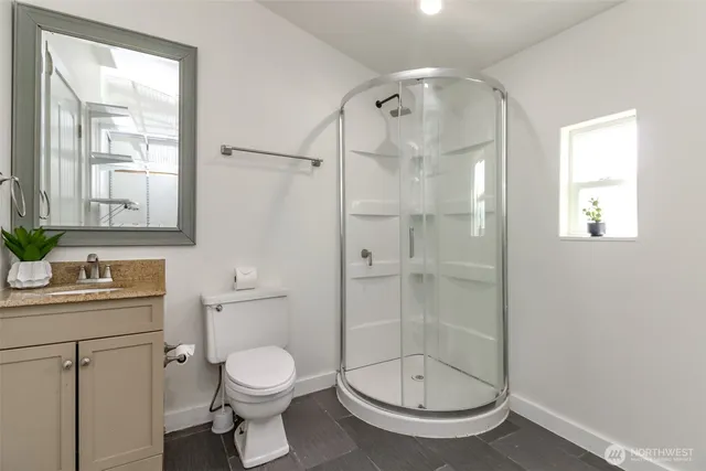 a bathroom with a toilet a sink and shower
