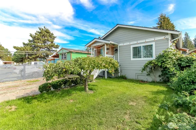 a front view of house with yard and outdoor seating