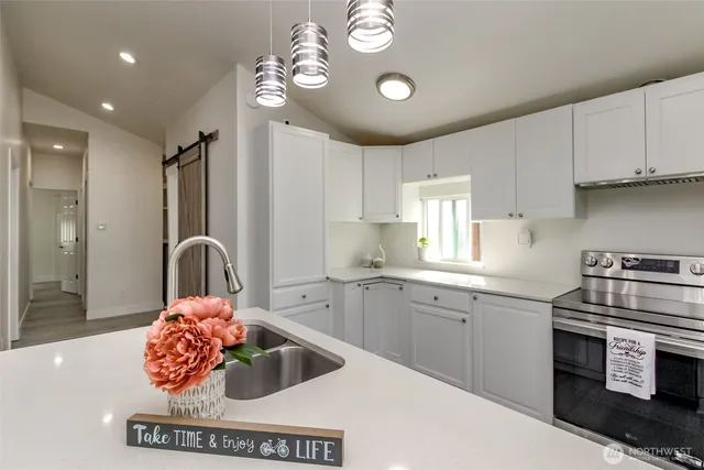 a kitchen with a sink stove and cabinets