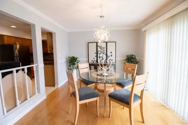 a view of a dining room with furniture window and wooden floor