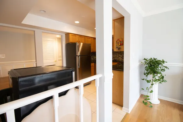 a view of entryway and hall with wooden floor