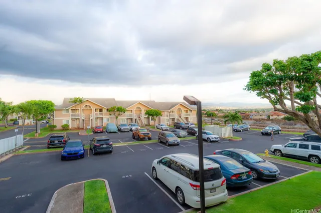 a city street with cars parked in front of it