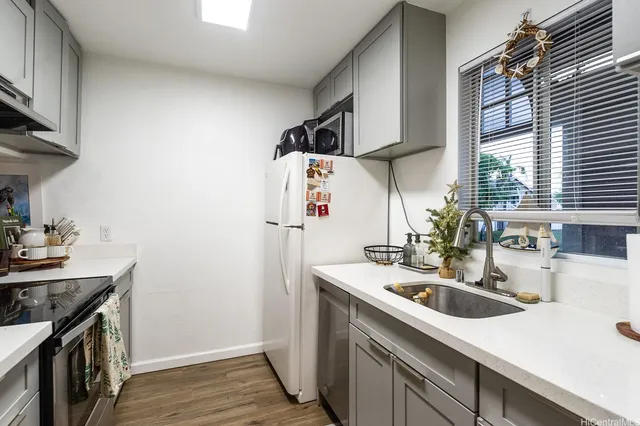 a kitchen that has a sink and a stove in it