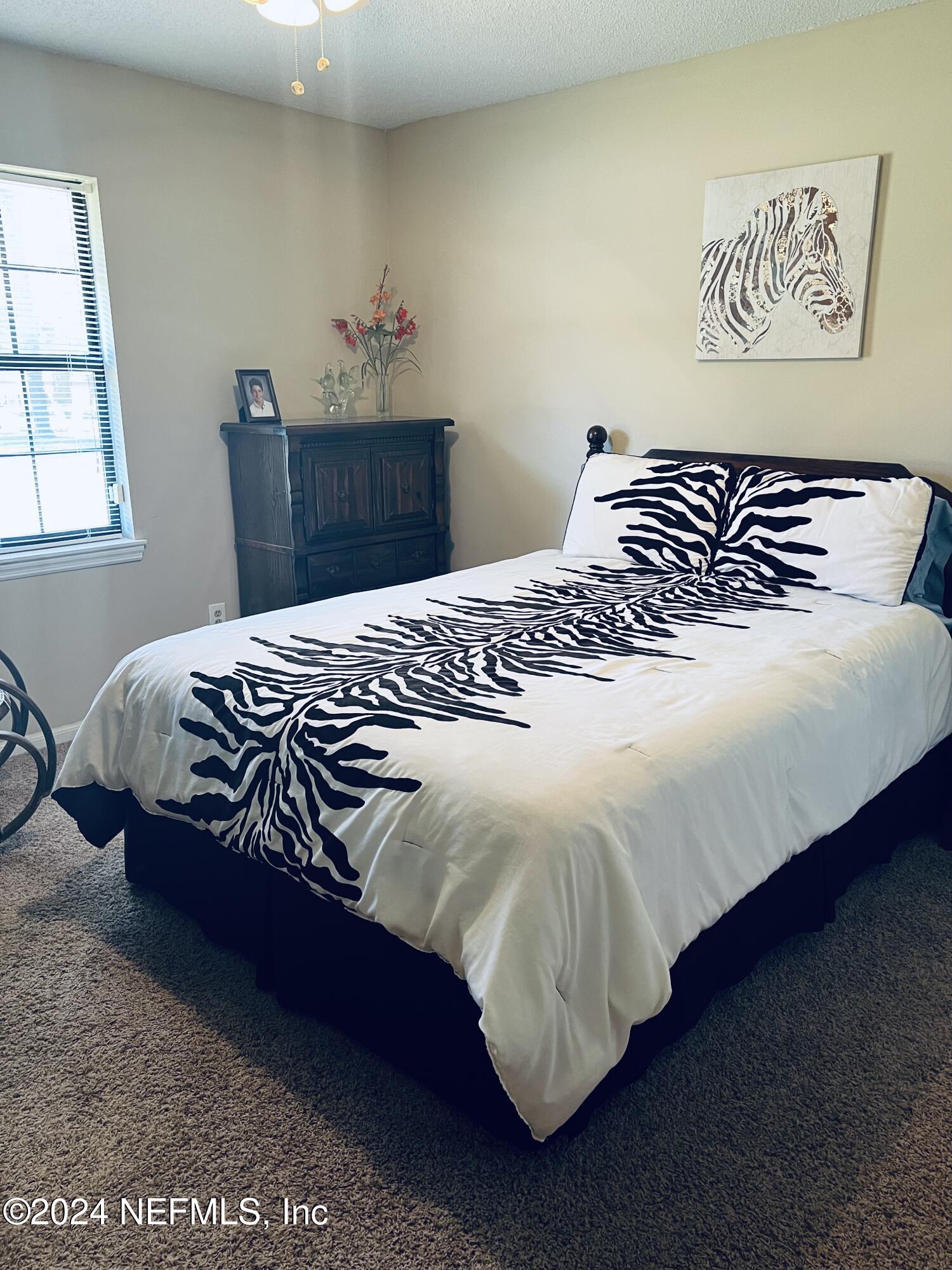 11375 Pine Loop Glen St. Mary, FL 32040 - Photo 11 of 17 a bedroom with a bed and a window