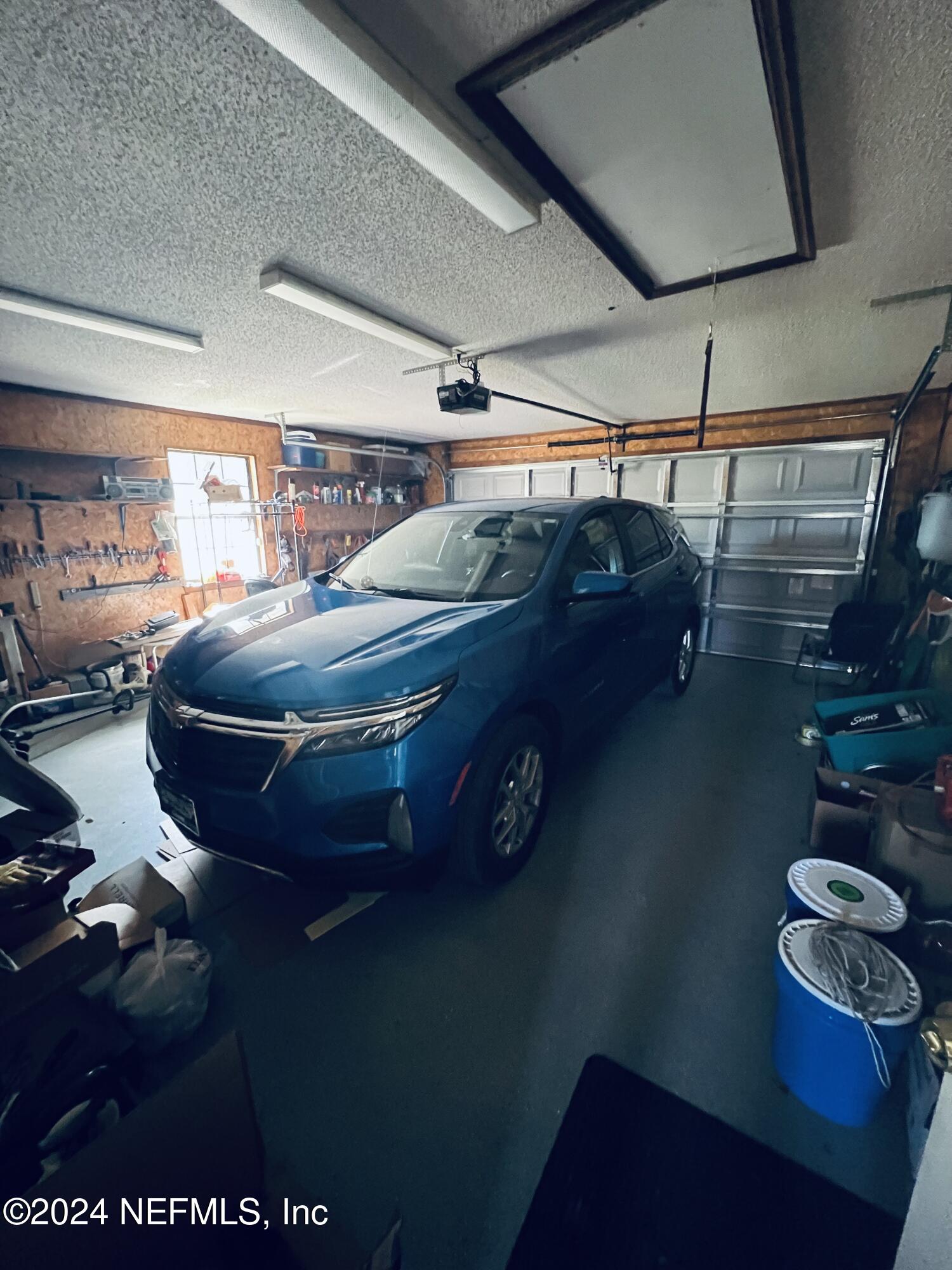 11375 Pine Loop Glen St. Mary, FL 32040 - Photo 17 of 17 a room with water heater and wooden floor
