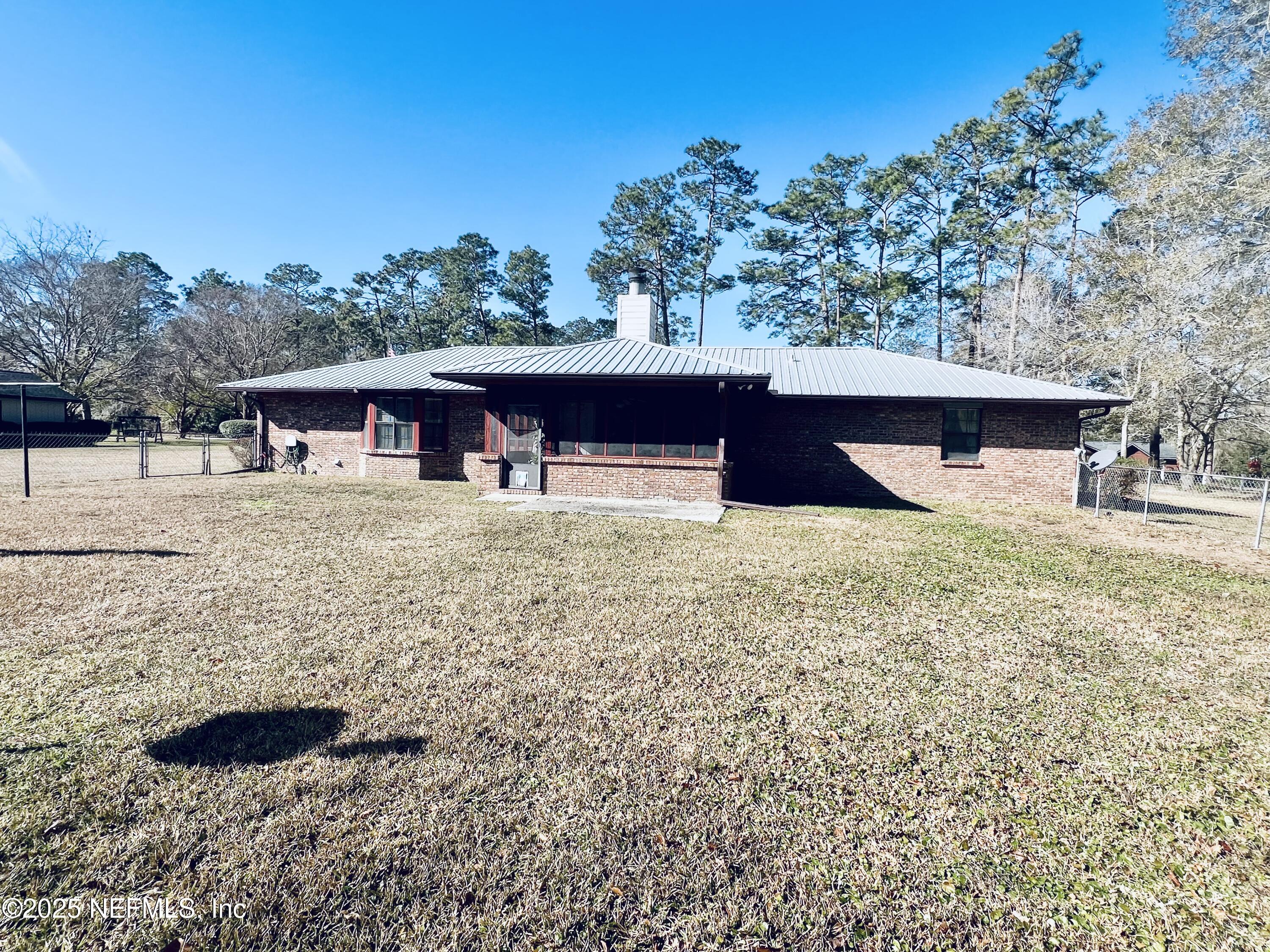 11375 Pine Loop Glen St. Mary, FL 32040 - Photo 2 of 17 a view of a house with a yard