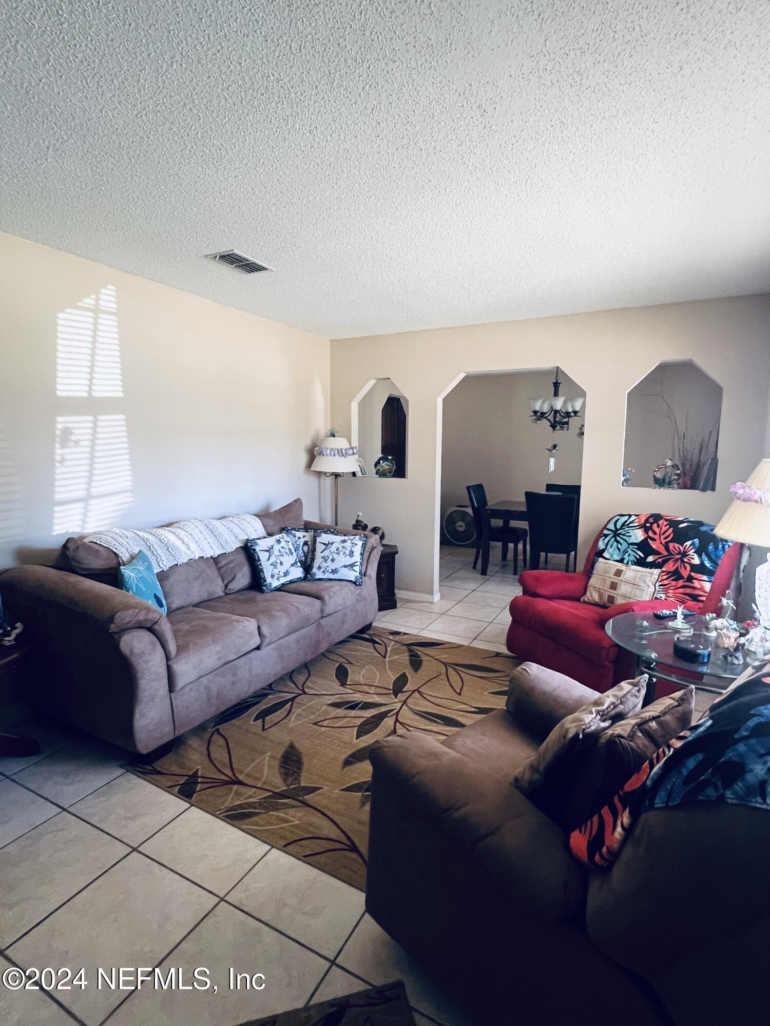 11375 Pine Loop Glen St. Mary, FL 32040 - Photo 5 of 17 a living room with furniture and a mirror