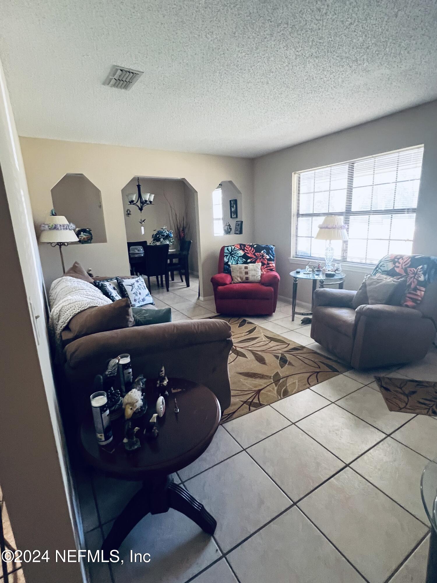 11375 Pine Loop Glen St. Mary, FL 32040 - Photo 6 of 17 a living room with furniture and a large window