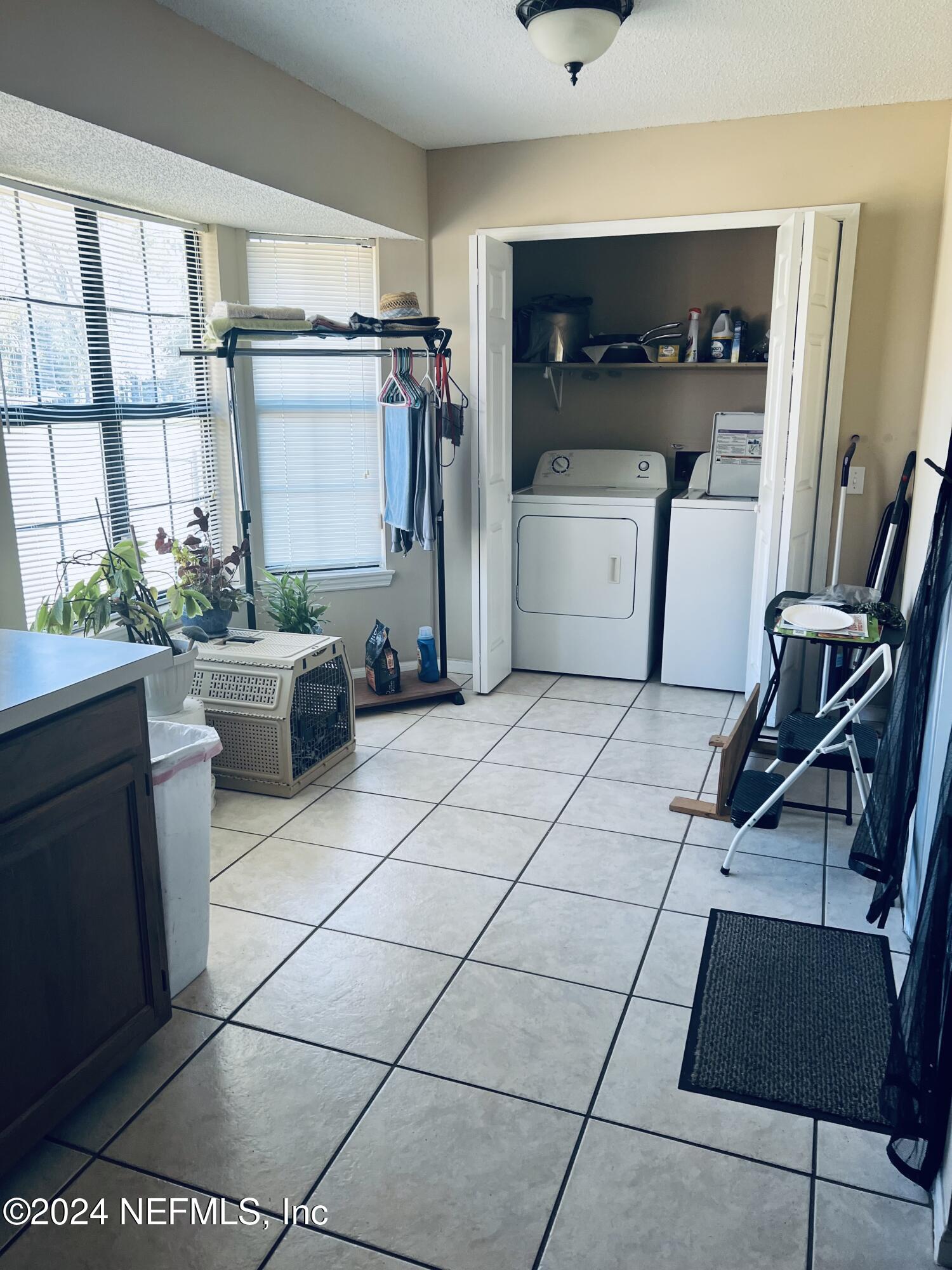 11375 Pine Loop Glen St. Mary, FL 32040 - Photo 9 of 17 a kitchen with a sink and a refrigerator