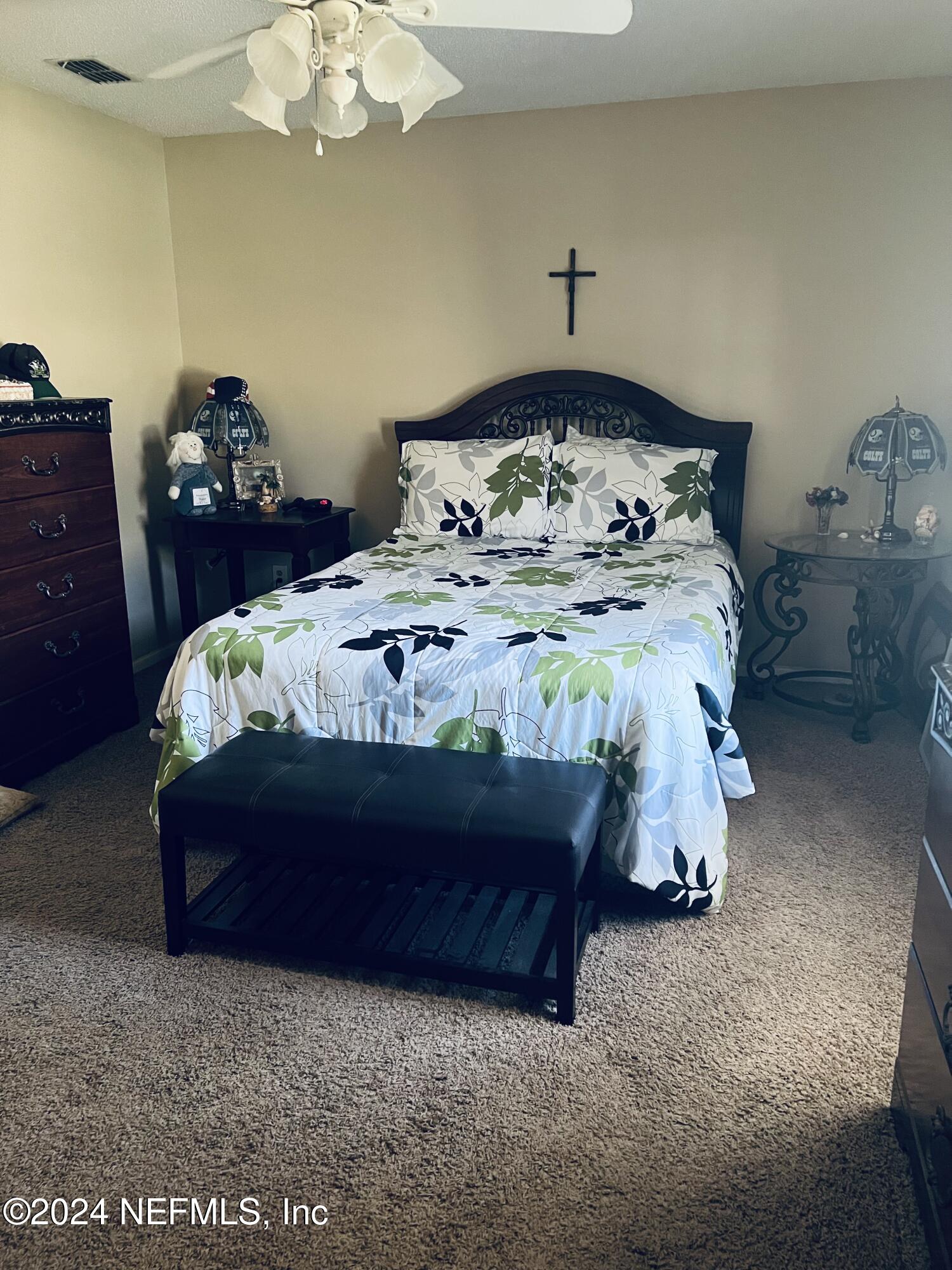 11375 Pine Loop Glen St. Mary, FL 32040 - Photo 10 of 17 a bedroom with a bed and a table