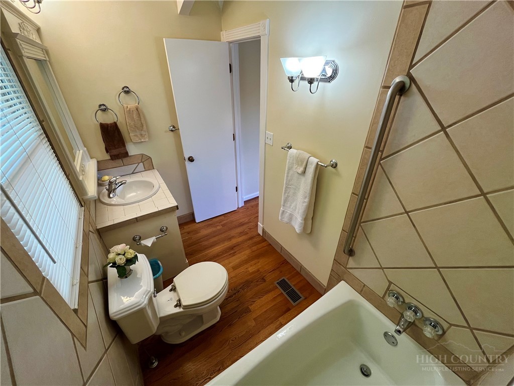 638 Ridge Road Glade Valley, NC 28627 - Photo 17 of 44 a bathroom with a sink mirror and toilet