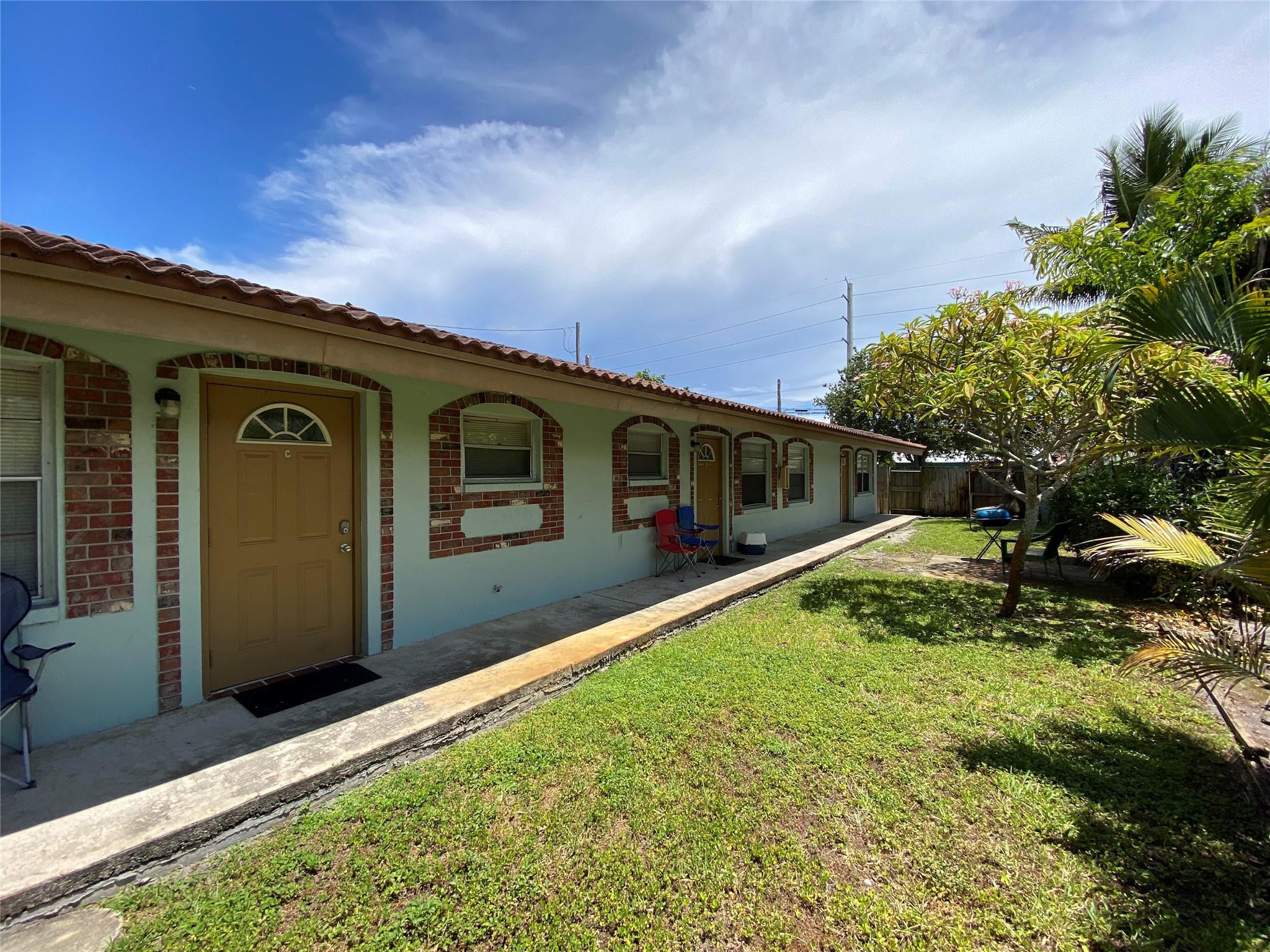 121 Southwest 15th Street, Unit C Pompano Beach, FL 33060 - Photo 13 of 13 a front view of a house with a yard