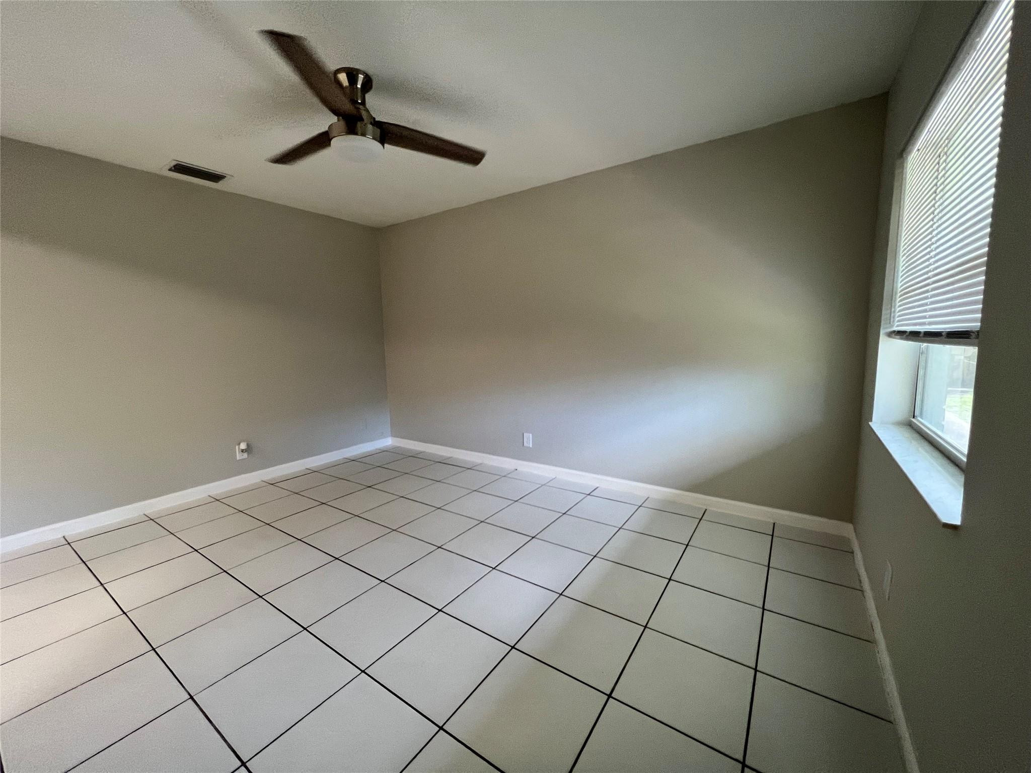 121 Southwest 15th Street, Unit C Pompano Beach, FL 33060 - Photo 3 of 13 a view of an empty room and window
