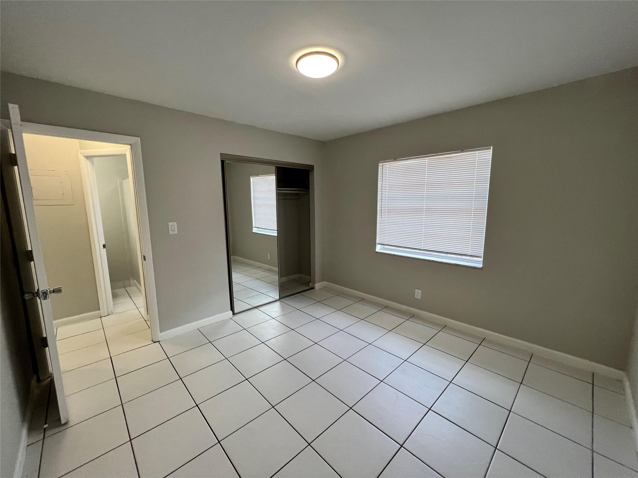 121 Southwest 15th Street, Unit C Pompano Beach, FL 33060 - Photo 6 of 13 a view of an empty room and window