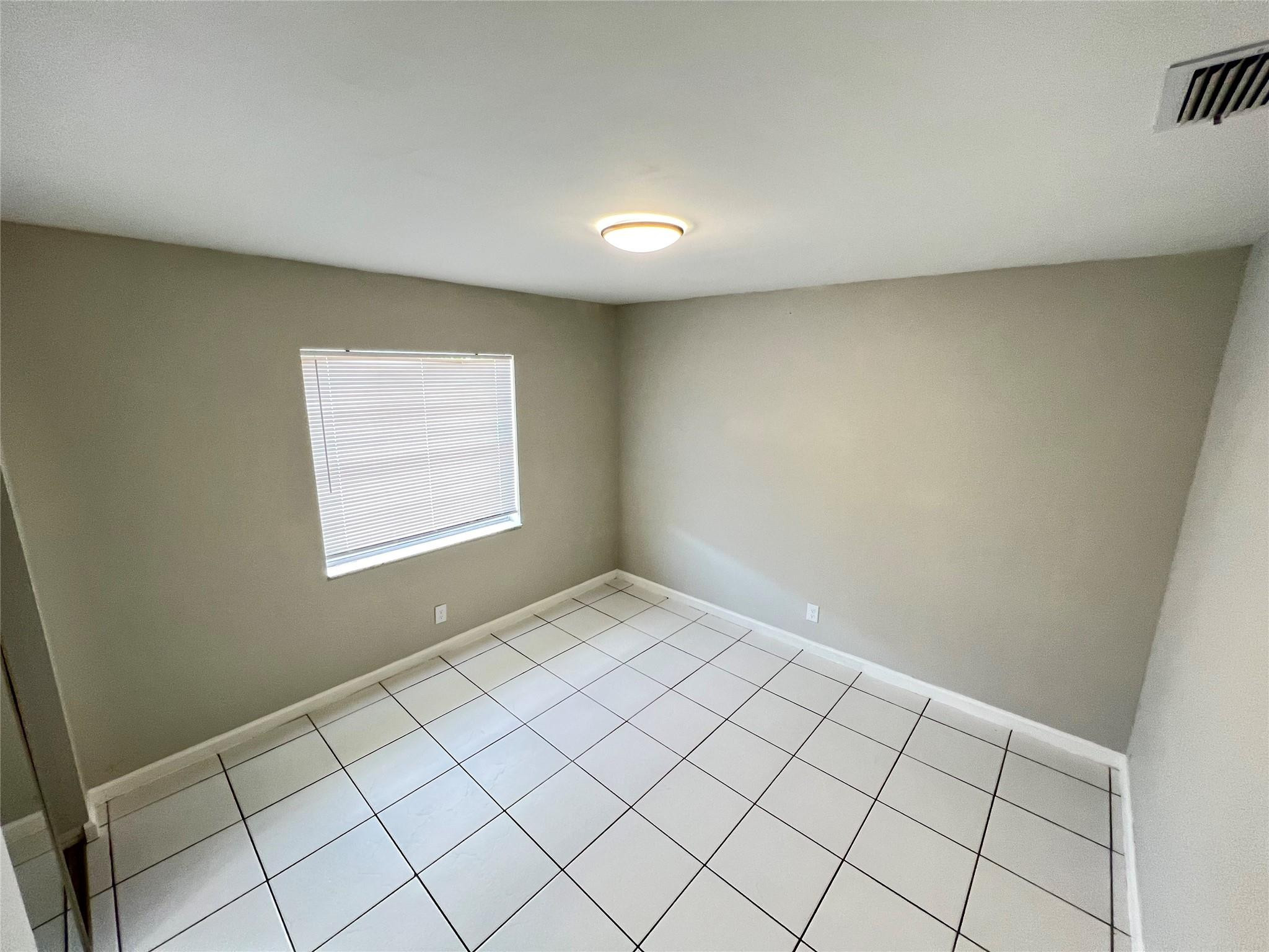 121 Southwest 15th Street, Unit C Pompano Beach, FL 33060 - Photo 7 of 13 a view of an empty room and window
