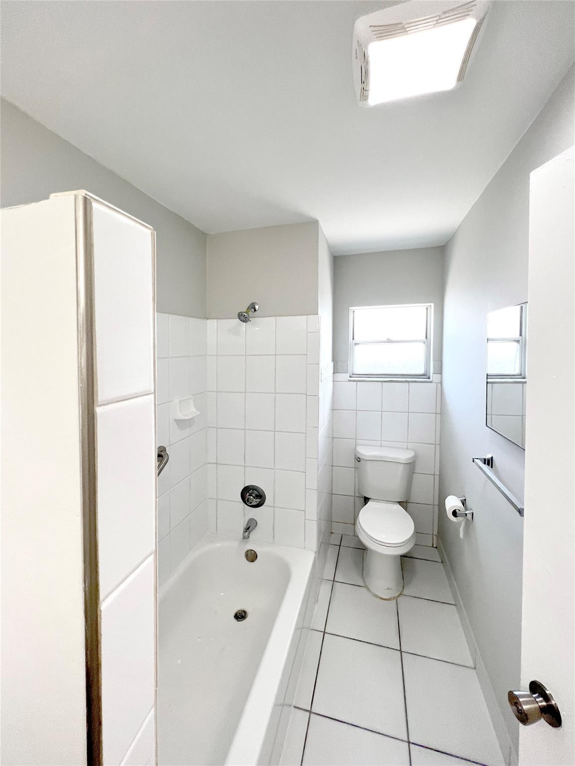 121 Southwest 15th Street, Unit C Pompano Beach, FL 33060 - Photo 10 of 13 a bathroom with a sink a toilet and shower