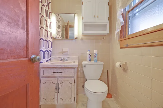a bathroom with a shower curtain and a sink