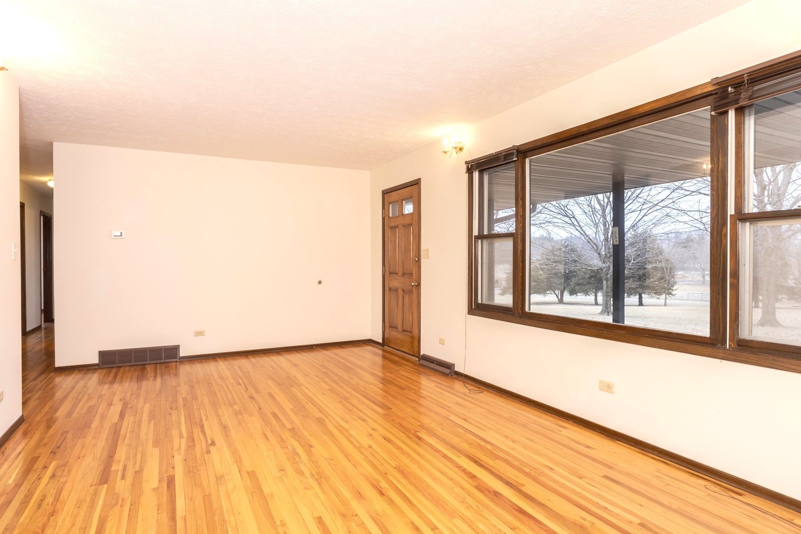 2804 Hendrix Drive Bloomington, IL 61704 - Photo 16 of 71 an empty room with wooden floor and windows