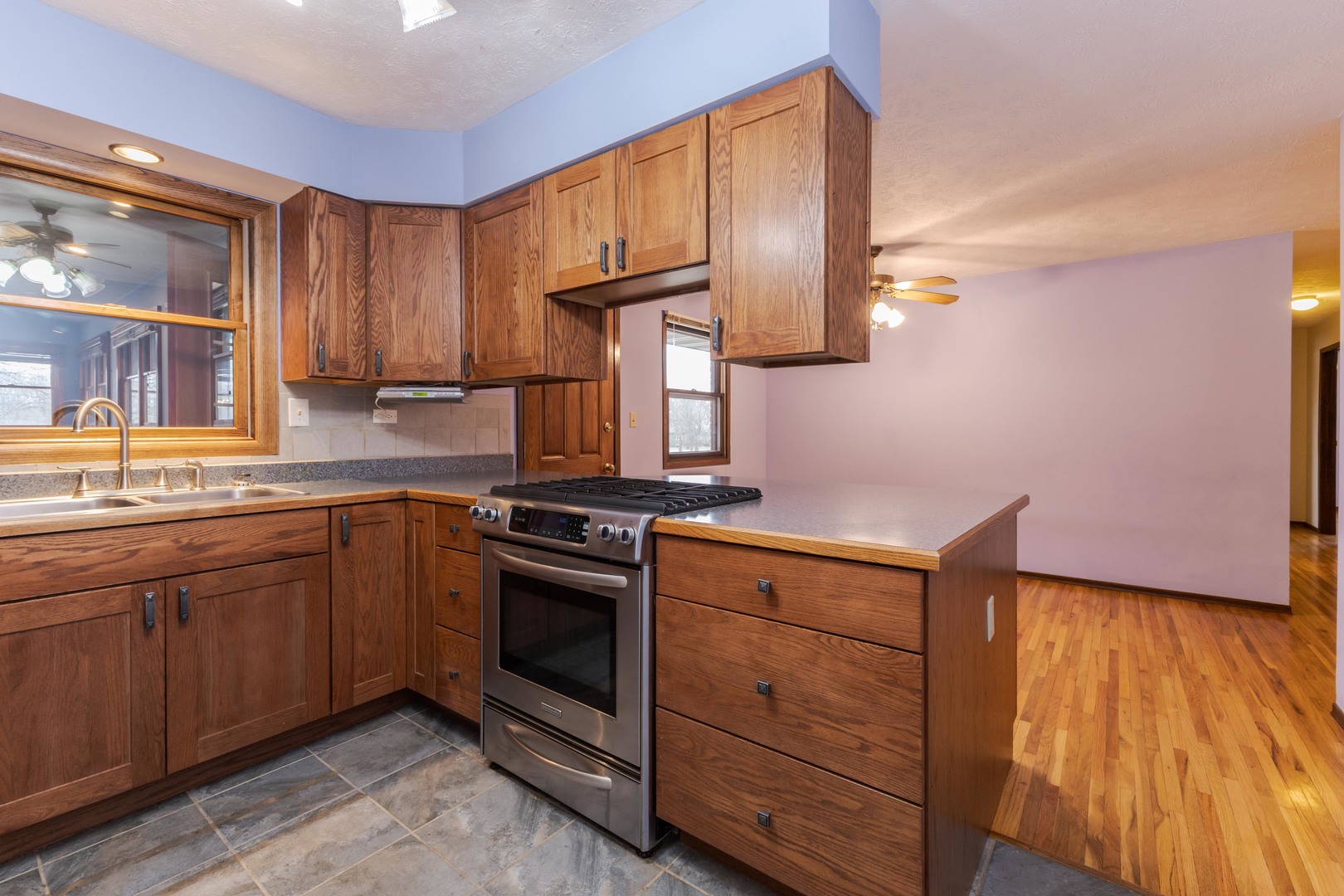 2804 Hendrix Drive Bloomington, IL 61704 - Photo 22 of 71 a kitchen with wooden cabinets and a sink