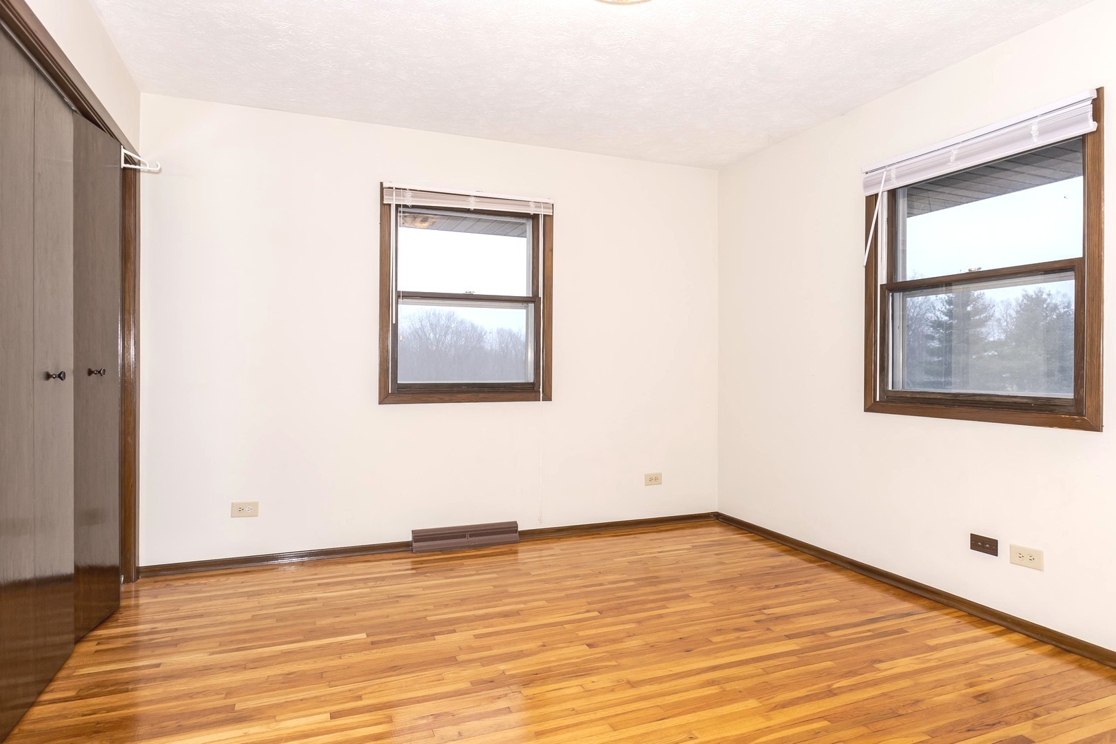 2804 Hendrix Drive Bloomington, IL 61704 - Photo 35 of 71 an empty room with wooden floor and windows