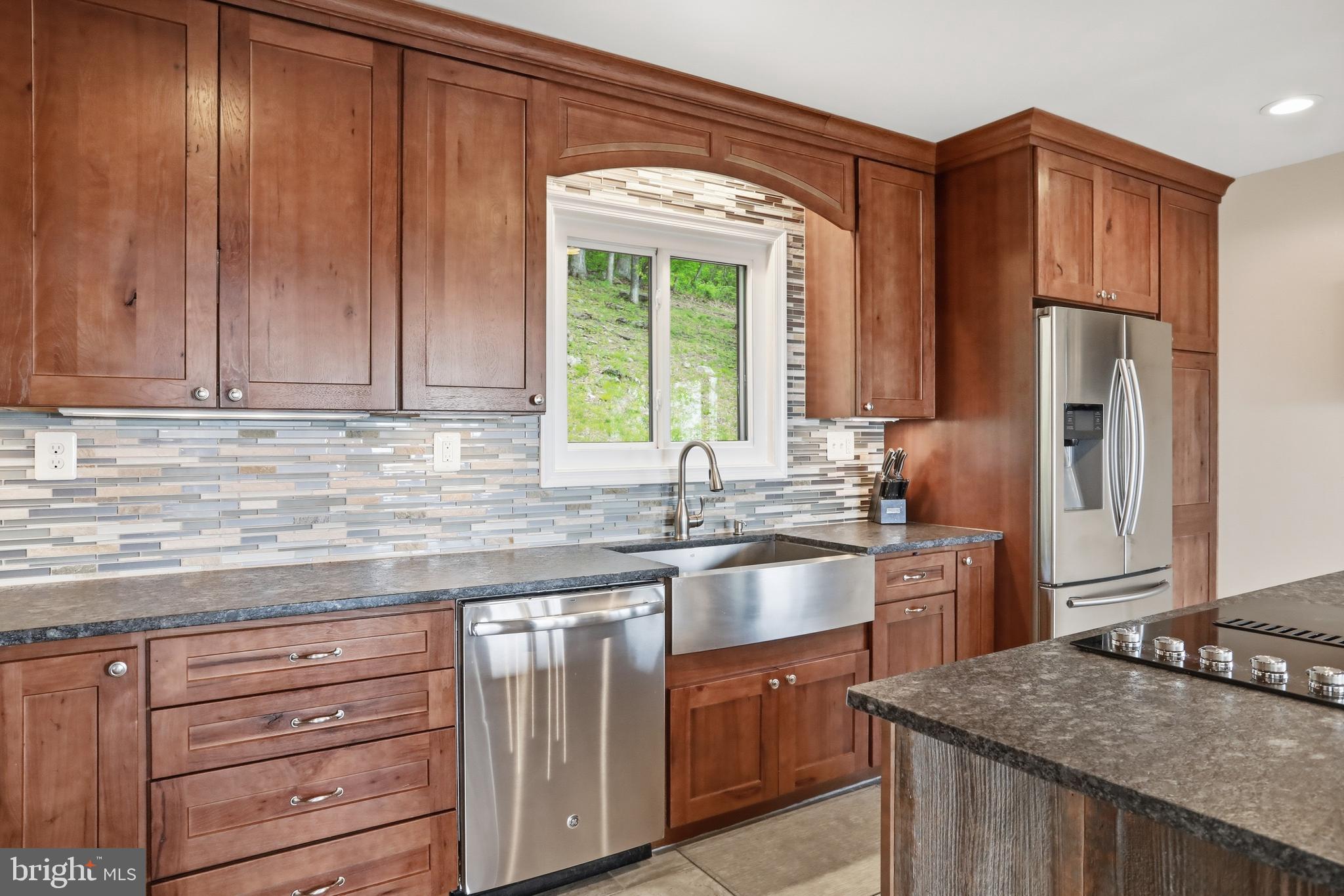 19897 Foresthill Road Bluemont, VA 20135 - Photo 15 of 39 a kitchen with granite countertop cabinets stainless steel appliances a sink and a window