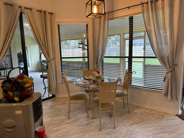 a view of a chairs and table in the balcony