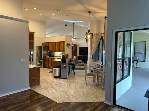 a kitchen with stainless steel appliances kitchen island granite countertop a refrigerator and a sink