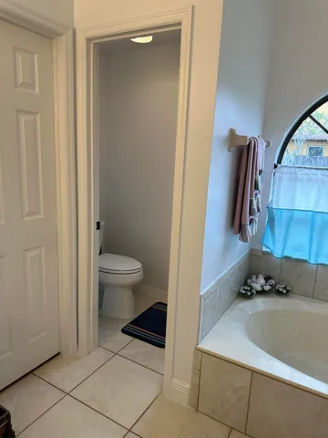 a bath tub sitting in a bathroom next to a window