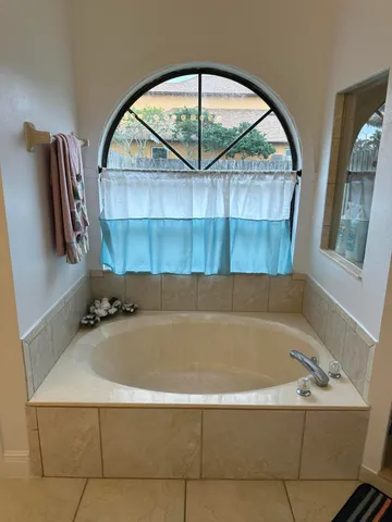 a bathroom with a bathtub and shower